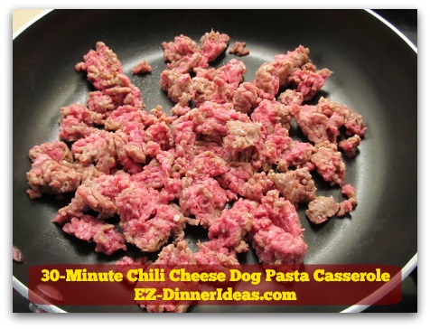 30-Minute Chili Cheese Dog Pasta Casserole - While pasta is cooking, brown meat in a big skillet