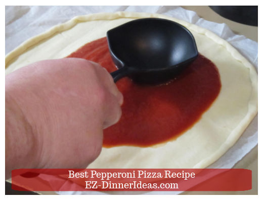 Tomato sauce on pizza dough