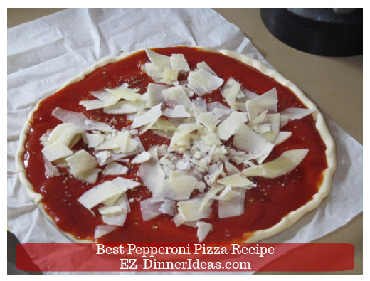 Parmesan cheese on pizza sauce