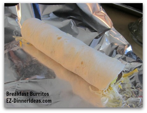 Breakfast Planning | Breakfast Burritos - Roll up the tortilla as tight as you can to make burrito Fold a corner of the foil over the burrito Breakfast Planning | Breakfast Burritos - Roll up the tortilla as tight as you can to make burrito Fold a corner of the foil over the burrito