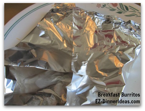 Breakfast Planning | Breakfast Burritos - Fold both sides in and roll towards the other end of the foil Breakfast Planning | Breakfast Burritos - Fold both sides in and roll towards the other end of the foil