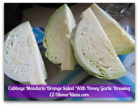 Cabbage Mandarin Orange Salad With Honey Garlic Dressing - Cut cabbage into quarters