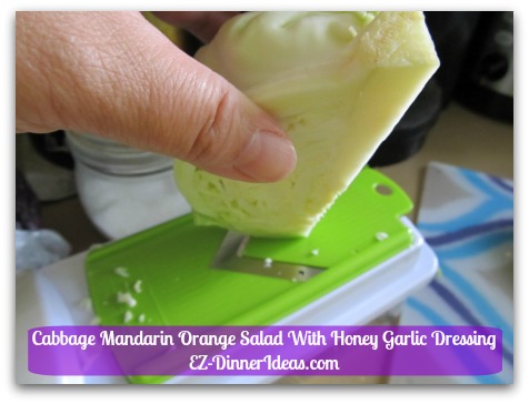 Cabbage Mandarin Orange Salad With Honey Garlic Dressing - Cut side faces opposite direction of the mandolin's blade