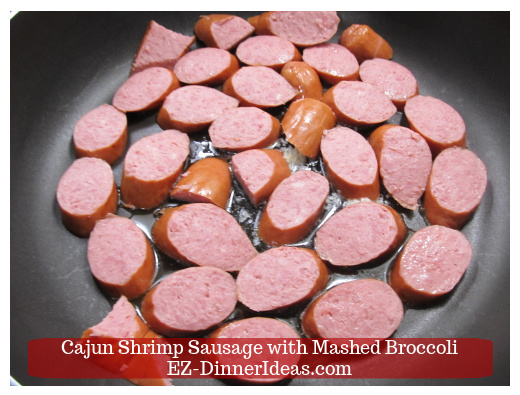 Single layer kielbasa sausage on skillet to brown. Single layer kielbasa sausage on skillet to brown.