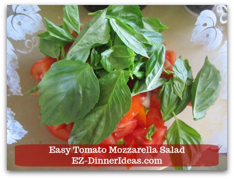 Caprese Salad Recipe | Easy Tomato Mozzarella Salad - Add a few pieces of fresh basil leaves into salad.