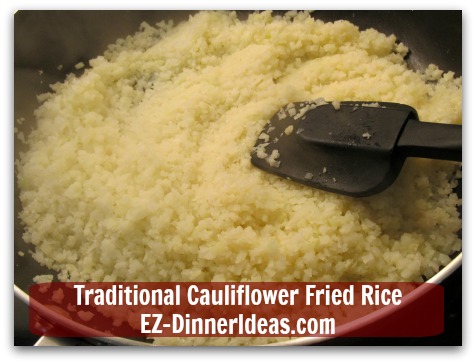 Traditional Cauliflower Fried Rice - Cook frozen cauliflower rice to thaw in a non-stick skillet