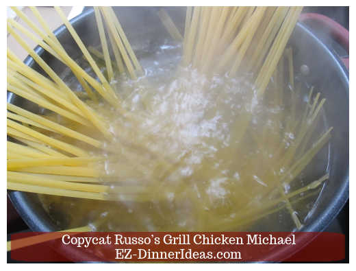 Adding pasta into the boiling water to cook Adding pasta into the boiling water to cook