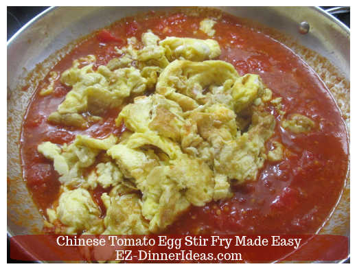 Adding eggs into the cooked tomatoes Adding eggs into the cooked tomatoes