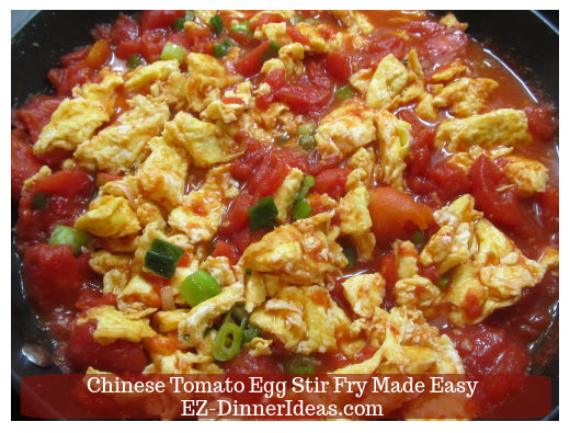 Stirring in egg with tomatoes to finish Stirring in egg with tomatoes to finish