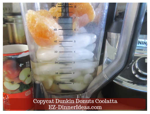 Water, ice cubes and frozen fruit concentrate in the blender
