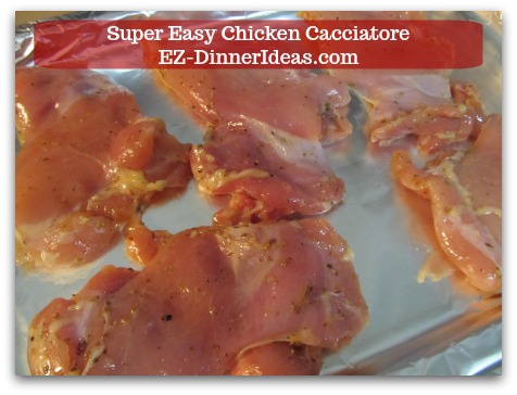 Italian Chicken Dinner Recipe | Super Easy Chicken Cacciatore - Single layer chicken on a foil lined baking sheet.