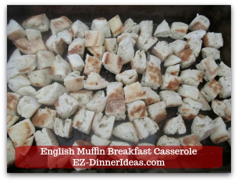 English Muffin Breakfast Casserole - Single layer muffin pieces at the bottom of a casserole dish.