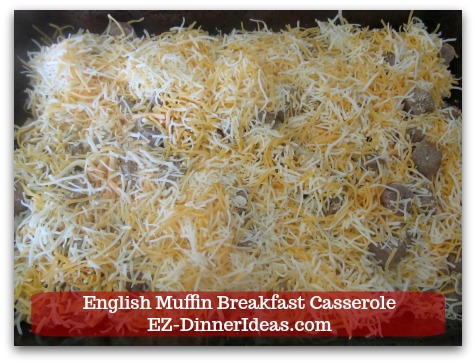 English Muffin Breakfast Casserole - Spread pre-shredded cheddar cheese evenly on top of muffin and sausage pieces.