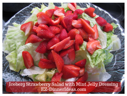 Cut strawberries on top of lettuce