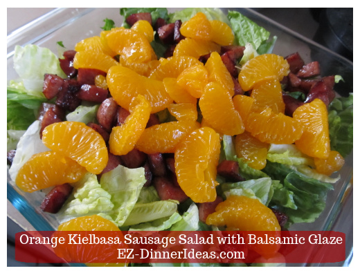 Mandarin orange with sausage and lettuce in salad bowl