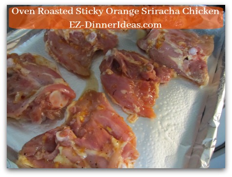 Oven Roasted Sticky Orange Sriracha Chicken - Skin side down on a lined baking sheet and roast