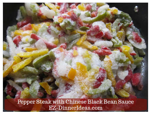 Frozen peppers and onions in hot skillet