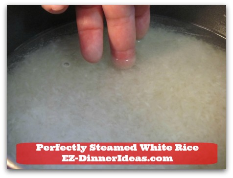 Perfectly Steamed White Rice - Measure it at different spots within the pot to ensure the right amount of water