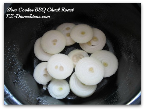 Slow Cooker BBQ Chuck Roast - layer sliced onion at the bottom of a slow cooker